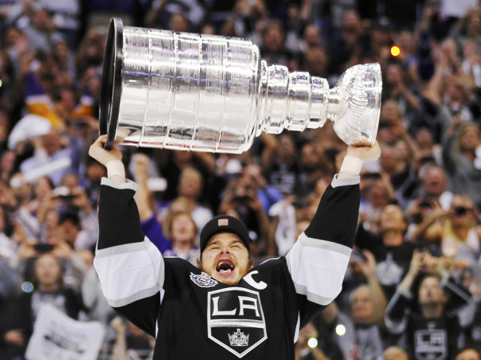 LA Kings captain Dustin Brown hoisting the Stanley Cup